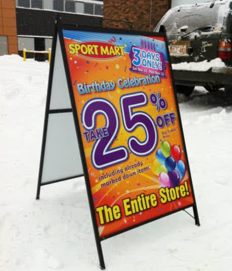 an orange sign advertising 25% off the entire store. The sign is 4 feet tall by 3 feet wide, and supported in an a-frame.