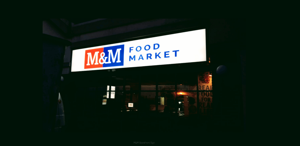 M and M Food Market sign at night